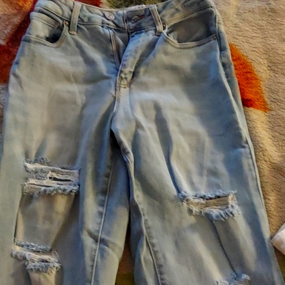 Flared ripped blue jeans